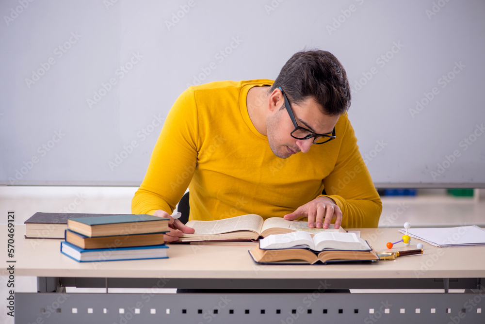 Young male student sitting in the classroom Young male student sitting in the classroom