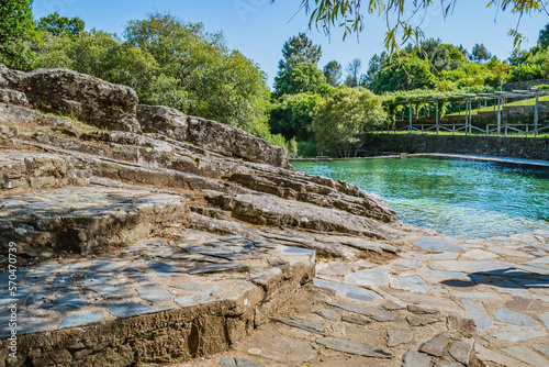 Steps in stone and rocks next to the transparent pool of Poço de Corga river beach, Castanheira de Pêra PORTUGAL photo