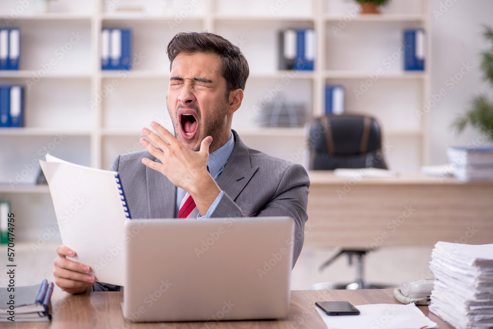 Young male employee working in the office Young male employee working in the office