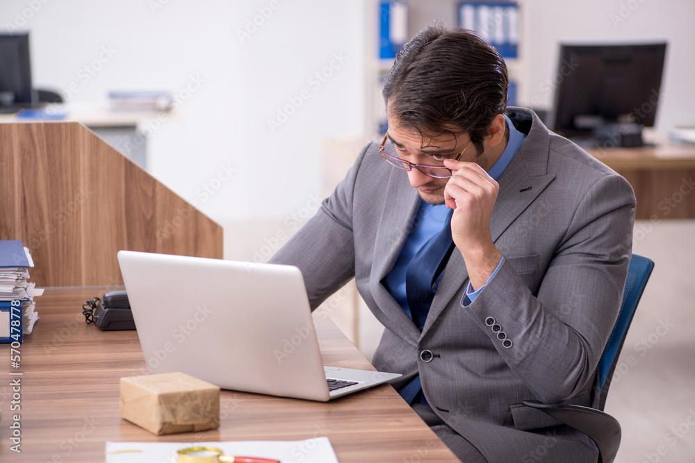 Young male employee working in the office Young male employee working in the office