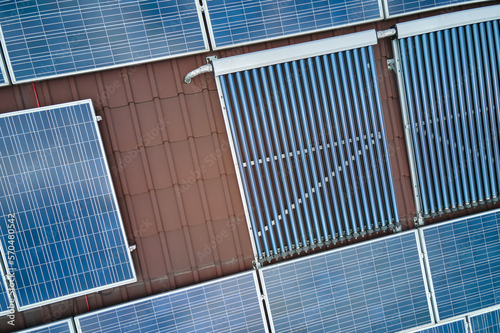 Φωτογραφία Building roof with rows of blue photovoltaic panels and vacuum air solar collectors for water heating and producing clean ecological electricity