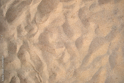 Flat view of clean yellow sand surface covering seaside beach. Sandy texture photo