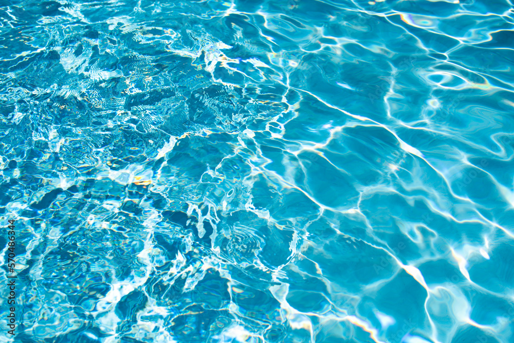 Obraz premium Water background, ripple waves. Blue swiming pool pattern. Sea surface. Water in swimming pool with sun reflection. Banner with copy space.