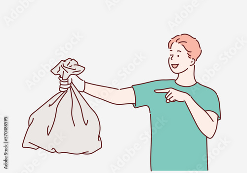 Young man holding a garbage bag and pointing isolated on gray background. Hand drawn style vector design illustrations.
