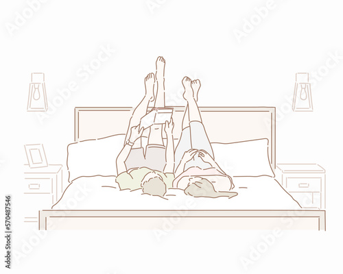 Couple reading a book lying in the bedHand drawn style vector design illustrations.