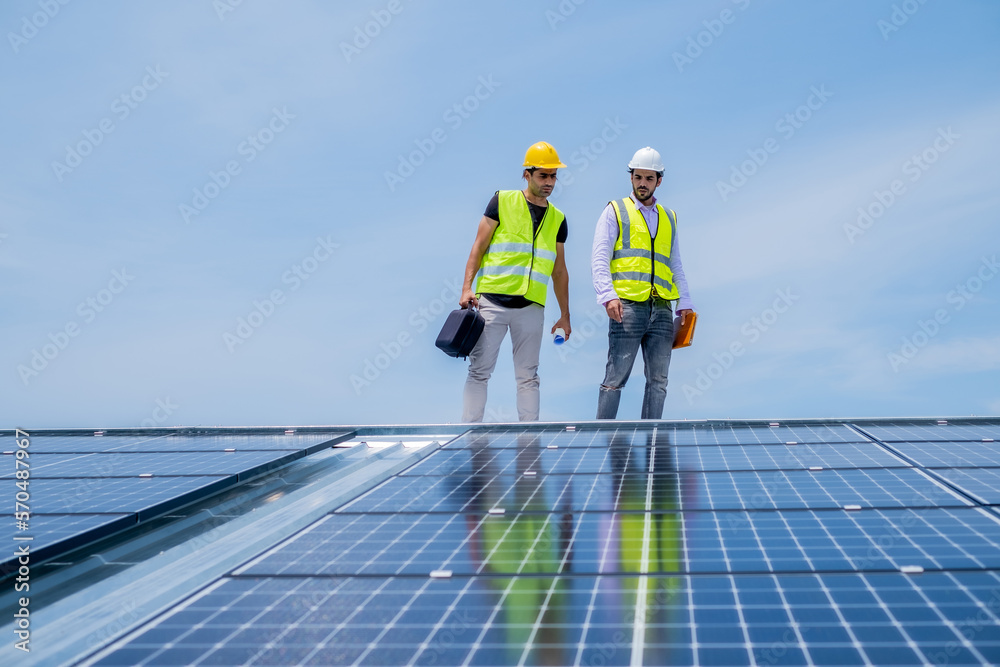 Leader and engineer walking on roof for checking solar panel was installed to check and maintainent, green energy innovation company, renew energy of the world. Leader and engineer walking on roof for checking solar panel was installed to check and maintainent, green energy innovation company, renew energy of the world.