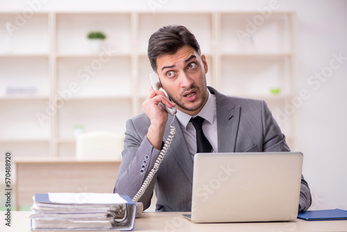 Young male employee working in the office