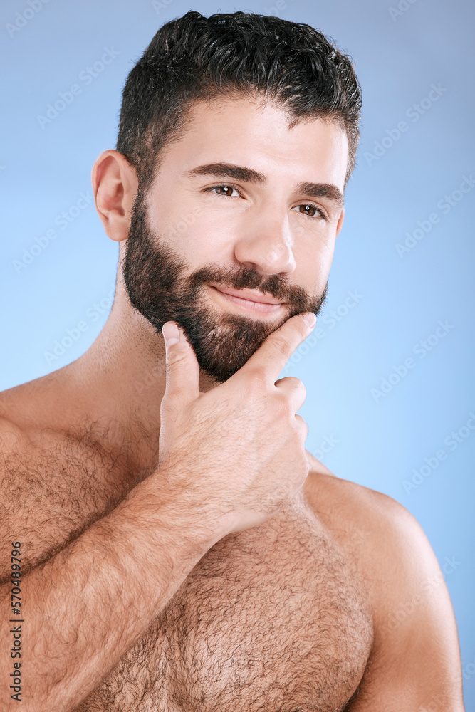 Naklejka premium Idea, beauty and skincare with a man model in studio on a blue background for natural wellness or grooming. Face, beard and skin with a handsome young male thinking about cosmetics or treatment