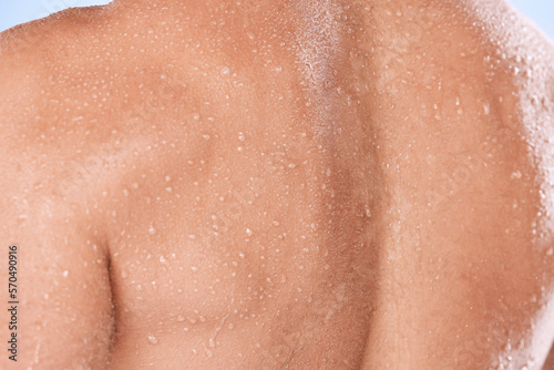 Man closeup  back and water drops for shower  fitness and skincare hygiene for cosmetics  health and dermatology. Shoulder  body zoom and person with workout  exercise or sports muscle training sweat