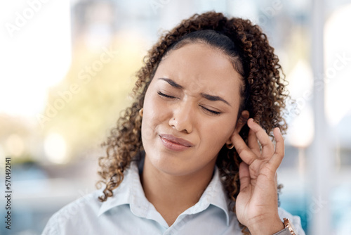 Earache, injury and woman with a hearing problem from noice, loud music and deaf. Stress, pain and business employee with tinnitus, pressure from sound and infection in the ear in the workplace