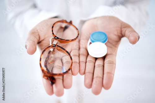 Eye care, choice with glasses or contact lenses in hands, closeup and vision with healthcare for eyes. Prescription lens, person with frame and plastic container, optometry with optician and health