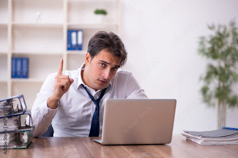 Young male employee working in the office Young male employee working in the office