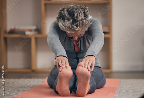 Elderly woman  yoga stretching and home on floor for wellness  health and fitness of body in retirement. Senior lady  workout and training on in living room for healthy muscle  legs and calm mindset