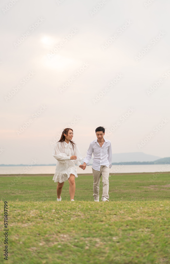 Happy young Asian couple in bride and groom clothing Happy young Asian couple in bride and groom clothing
