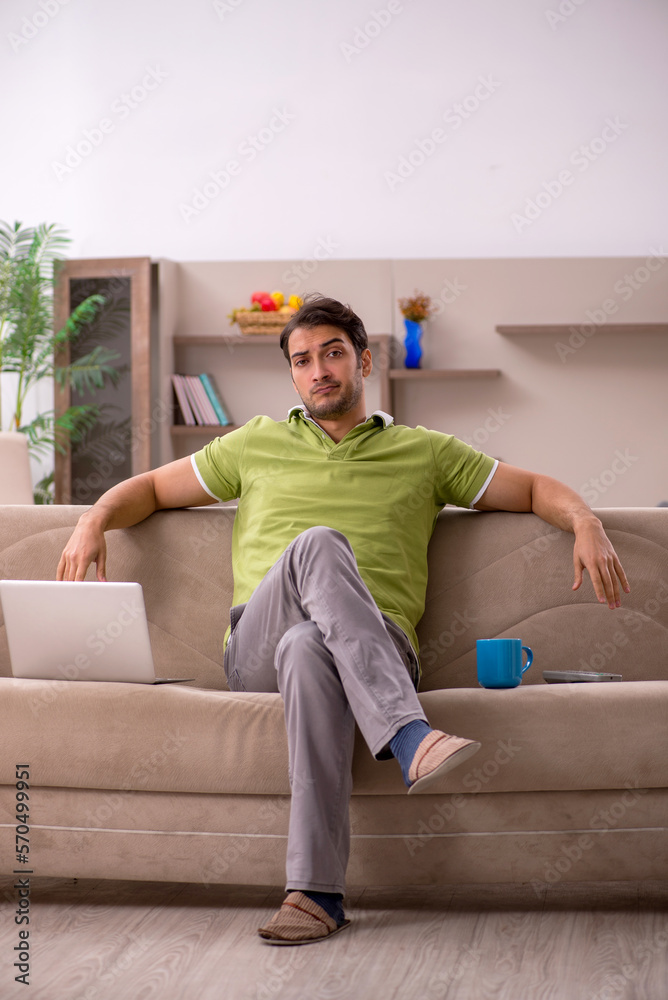 Fototapeta premium Young male freelancer working from home