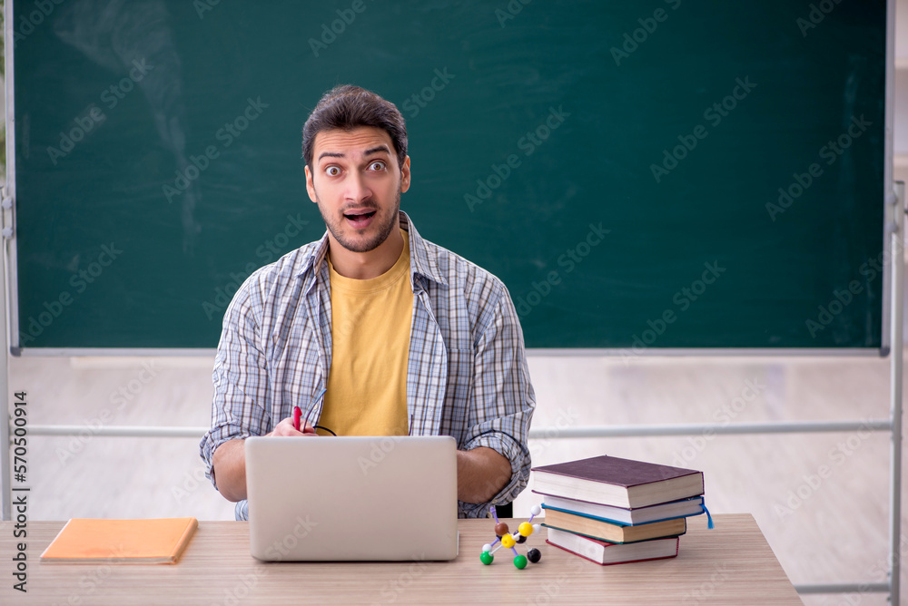 Young male student in telestudying concept Young male student in telestudying concept