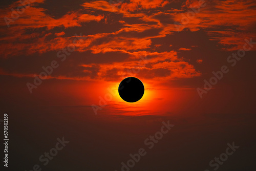 Total solar eclipse on the red orange sky in the morning © darkfoxelixir