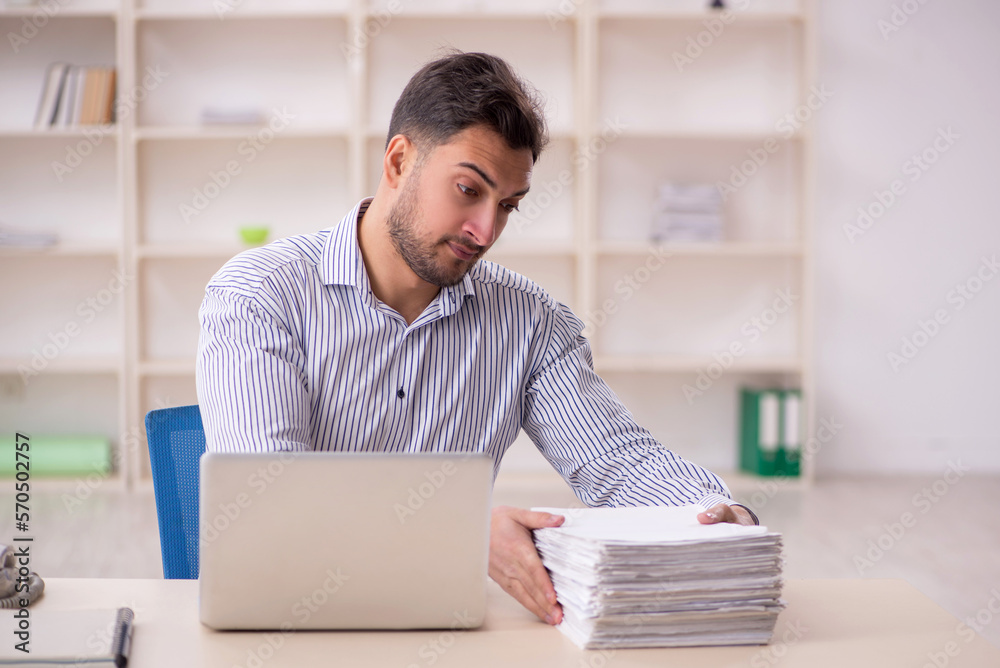 Young male employee working in the office