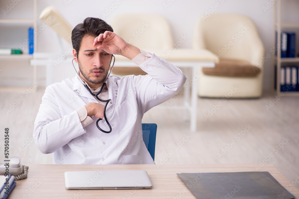 Young male doctor working in the clinic Young male doctor working in the clinic