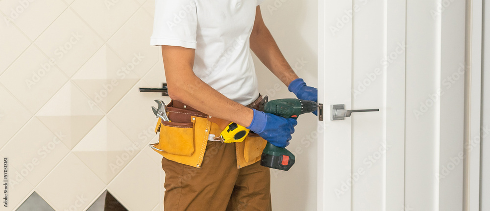 Handyman Fitting A New Door Using A Screwdriver At Home Handyman Fitting A New Door Using A Screwdriver At Home