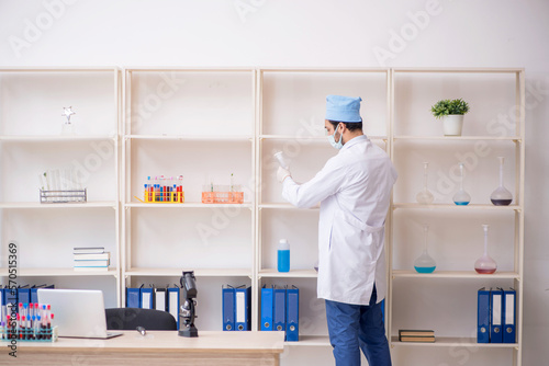 Young male chemist working at the lab