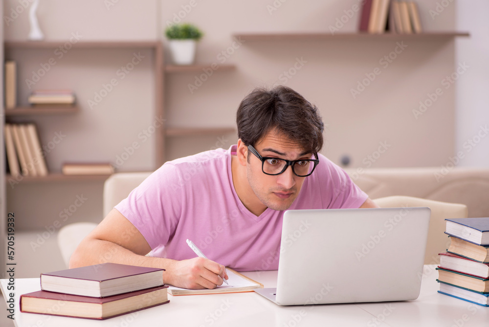 Young male student preparing for exams at home Young male student preparing for exams at home