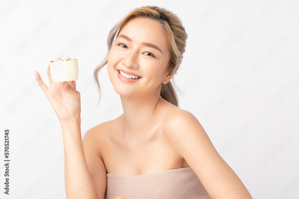 Happy beautiful young asian woman holding cosmetic cream blank bottle, Fashion model, Health wellness, Beautiful girl skin care and facial treatment. Isolated on white background. Happy beautiful young asian woman holding cosmetic cream blank bottle, Fashion model, Health wellness, Beautiful girl skin care and facial treatment. Isolated on white background.