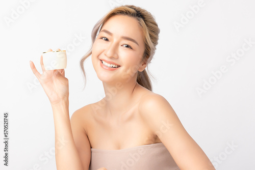 Happy beautiful young asian woman holding cosmetic cream blank bottle, Fashion model, Health wellness, Beautiful girl skin care and facial treatment. Isolated on white background.