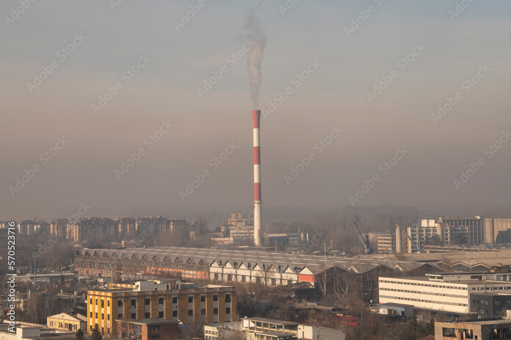 Obraz premium Smog lies over the skyline of Historical architecture of Belgrade city. Poor visibility, smog, caused by air pollution. Rooftop view. Emissions of plants and factories. Belgrade, Serbia 21.12.2022