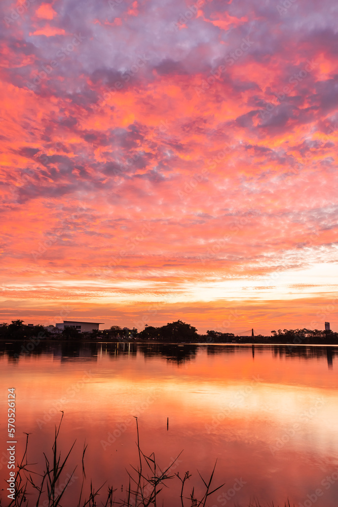 sunset nearly fall from the sky on the horizon reflected into the water