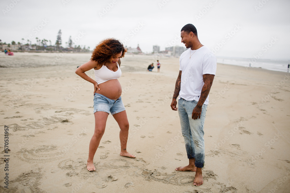 Mixed Race Couple Goofing Around on Beach Mixed Race Couple Goofing Around on Beach