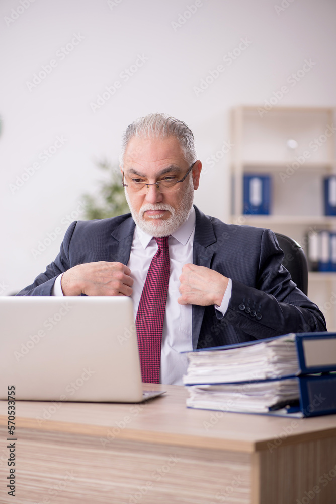 Old male employee and too much work in the office Old male employee and too much work in the office