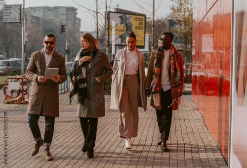 Four business people walking