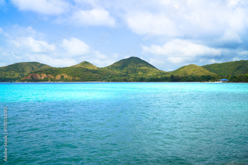 An island in the sea with a blue sky and clouds in the background.Pattaya Vacation,Thailand