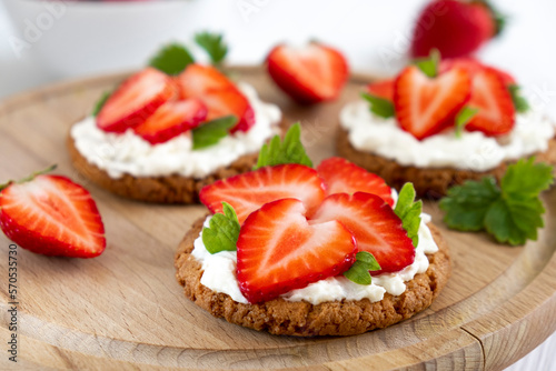 Homemade healthy crispbread bruschetta with strawberry and cream cheese. Healthy snack, keto diet or dieting concept. Recipe of vegan food for everyday cooking.