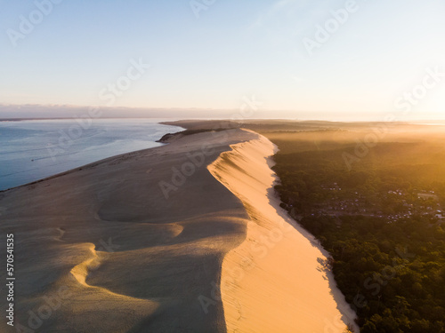 Dune du Pilat sand mountain and pine forest in sunrise drone aerial view panoramic in Arcachon Landes Aquitaine France