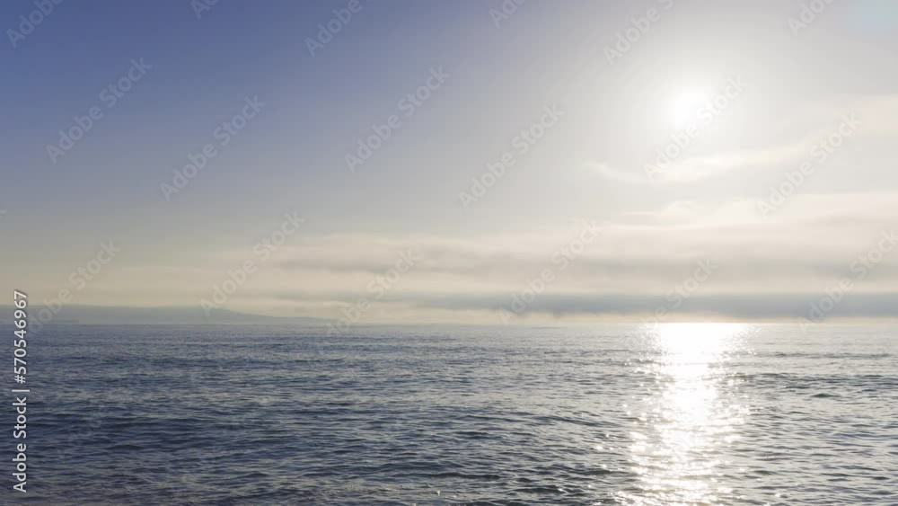 Black Sea and beach nearby against a sky with clouds and a dawn sun Black Sea and beach nearby against a sky with clouds and a dawn sun