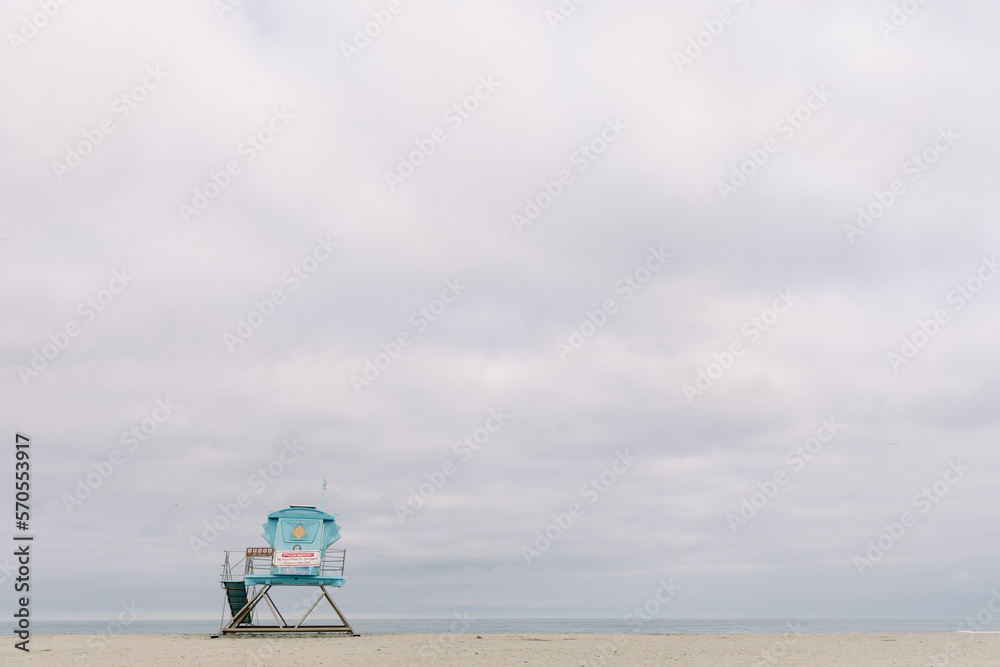 Fine art beach scene with lifeguard Tower and cloudy skies