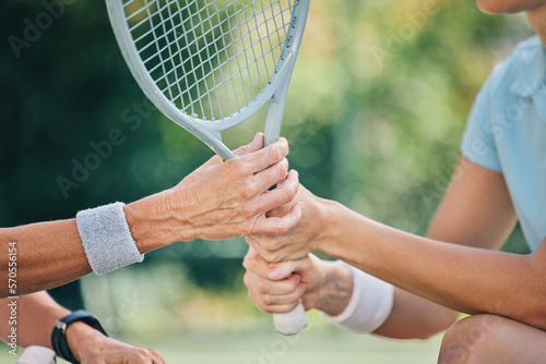 Hands together, tennis racket and coach with woman athlete, support and helping hand at training. Women, coaching and learning for sports, goals and motivation by blurred background outdoor for goal