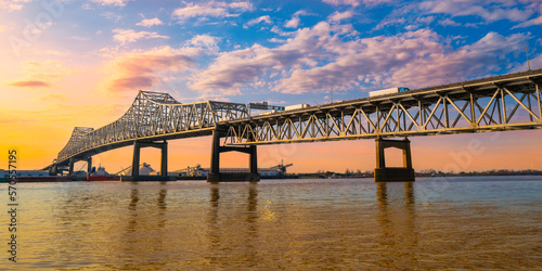The Horace Wilkinson Bridge and Mississippi River at sunset with warm glowing clouds on the blue sky in Baton Rouge, Louisiana, USA