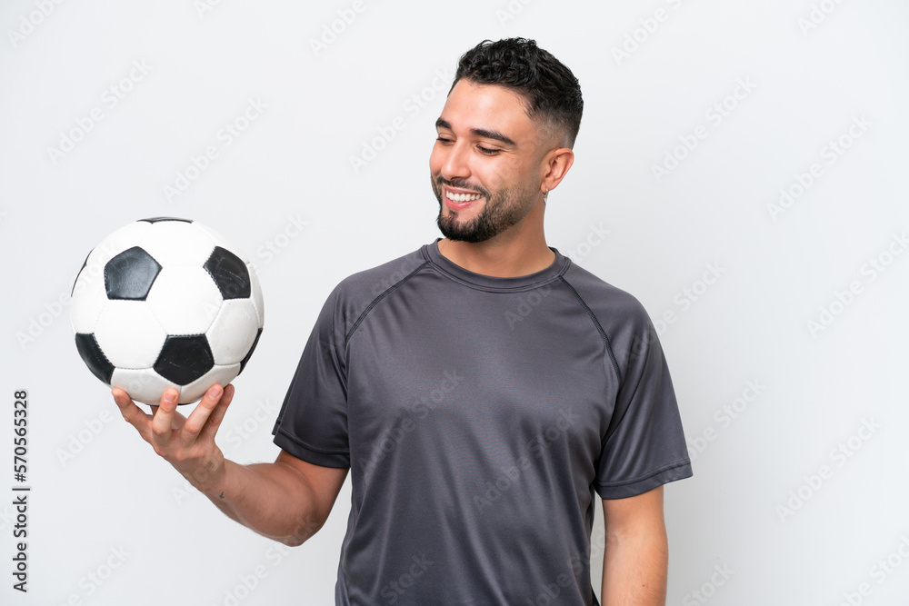 Arab young football player man isolated on white background looking to the side and smiling Arab young football player man isolated on white background looking to the side and smiling