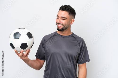Arab young football player man isolated on white background looking to the side and smiling