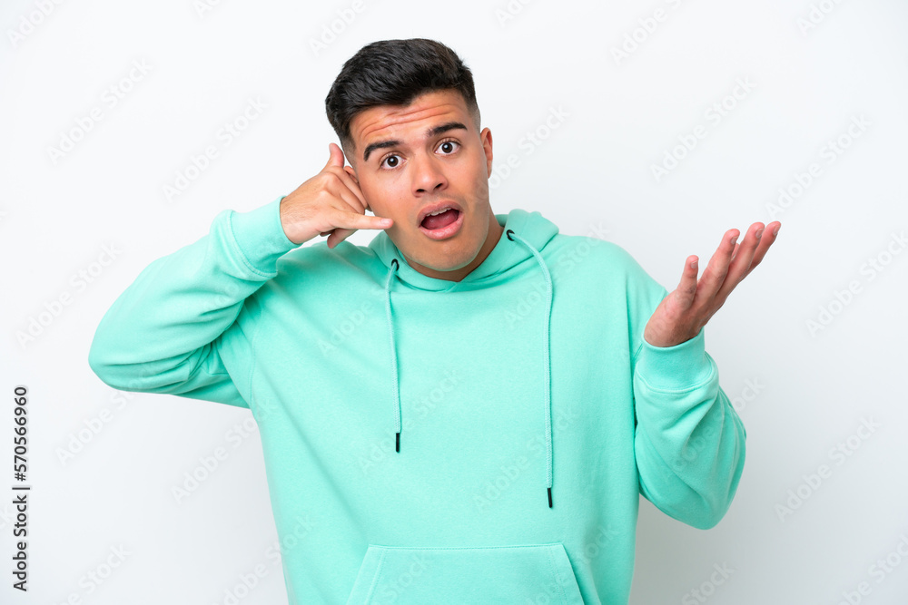 Young caucasian handsome man isolated on white background making phone gesture and doubting Young caucasian handsome man isolated on white background making phone gesture and doubting