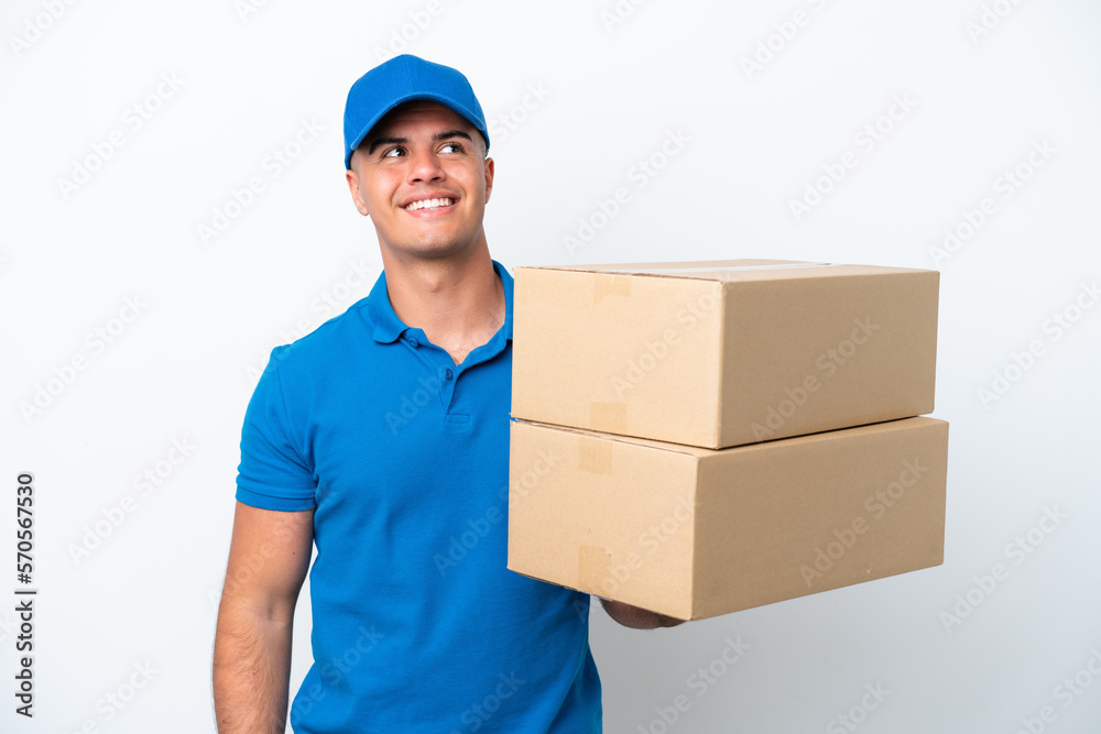 Delivery caucasian man isolated on white background thinking an idea while looking up Delivery caucasian man isolated on white background thinking an idea while looking up