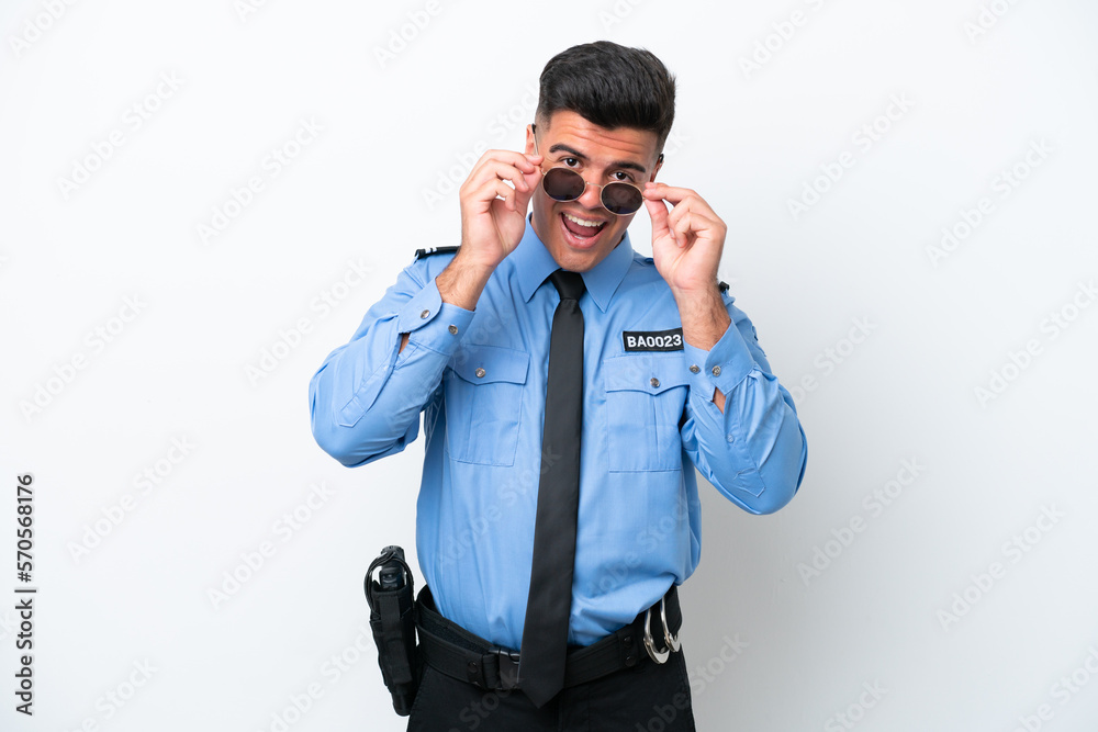 Young police caucasian man isolated on white background with glasses and surprised Young police caucasian man isolated on white background with glasses and surprised