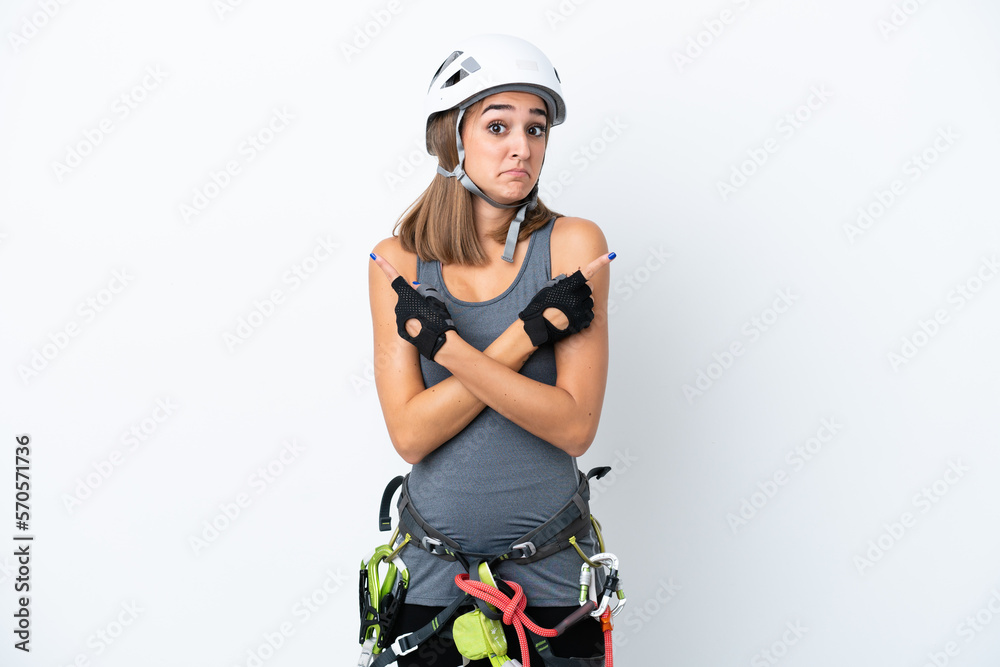 Young rock-climber woman isolated on white background pointing to the laterals having doubts Young rock-climber woman isolated on white background pointing to the laterals having doubts