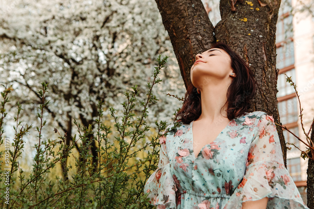 Portrait of charming pretty woman dressed flowery dress posing near apple cherry tree blossoms blooming flowers in the garden park in early spring nature. Fashion, girl model with black hair
Portrait of charming pretty woman dressed flowery dress posing near apple cherry tree blossoms blooming flowers in the garden park in early spring nature. Fashion, girl model with black hair