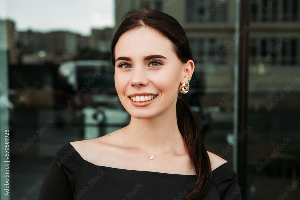 Pretty brunette caucasian woman standing outside street with white teeth beaming healthy smiling lady. Happy millennial girl model posing looking at the camera, head shot portrait.
Pretty brunette caucasian woman standing outside street with white teeth beaming healthy smiling lady. Happy millennial girl model posing looking at the camera, head shot portrait.