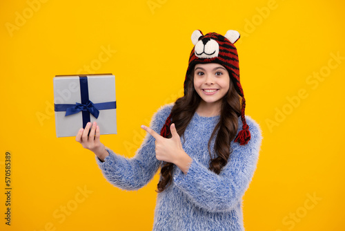 Teenager child with gift box. Present for holidays. Happy birthday  Valentines day  New Year or Christmas. Kid hold present box. Happy teenage girl  positive and smiling emotions.