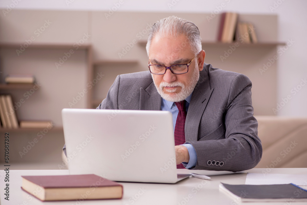 Old male employee working from home during pandemic Old male employee working from home during pandemic